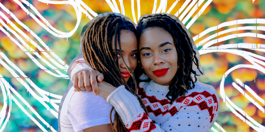 Two African American Women Hugging & Smiling